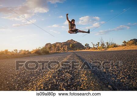 Stock Photography - Man doing flying kick, Joshua Tree National Park, California, US. Fotosearch