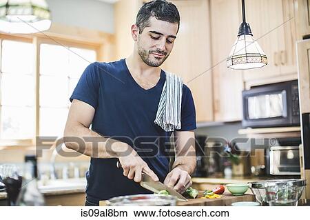 Man preparing food in kitchen View Large Photo Image Picture - Man preparing food in kitchen. Fotosearch