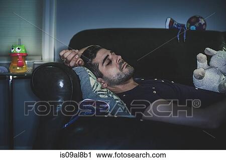 Man sleeping on sofa View Large Photo Image Stock Image - Man sleeping on sofa. Fotosearch