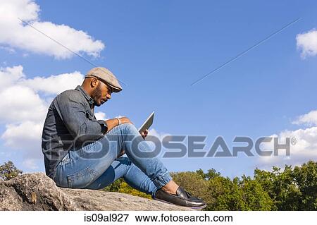 Stock Photo - Man using digital tablet. Fotosearch