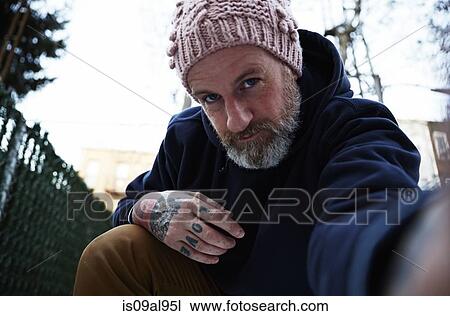 Mature man crouching with arm out to take self portrait View Large Photo Image Stock Image - Mature man crouching with arm out to take self portrait. Fotosearch