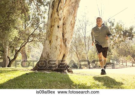 Stock Photo - Mature man running through park. Fotosearch