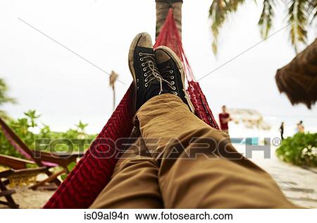 Picture - Mature mans self portrait of legs in beach hammock. Fotosearch