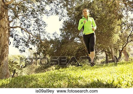 Mature woman running through park View Large Photo Image Stock Photo - Mature woman running through park. Fotosearch