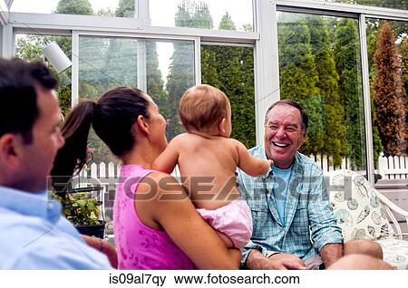 Mid adult couple and baby daughter and grandfather in conservatory View Large Photo Image Stock Photo - Mid adult couple and baby daughter and grandfather in conservatory. Fotosearch
