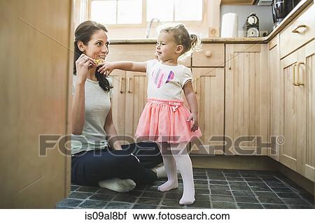Mother and daughter playing in kitchen View Large Photo Image Stock Image - Mother and daughter playing in kitchen. Fotosearch