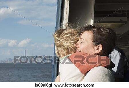 Mother hugging son on boat View Large Photo Image Stock Image - Mother hugging son on boat. Fotosearch