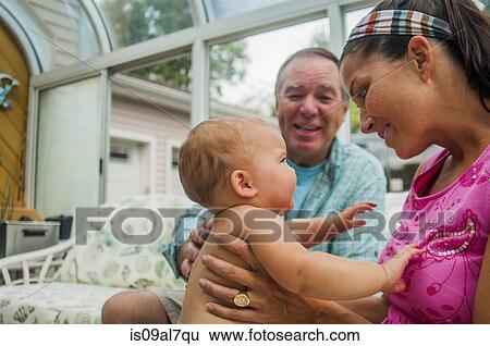 Mother with baby daughter and grandfather in conservatory View Large Photo Image Stock Photograph - Mother with baby daughter and grandfather in conservatory. Fotosearch