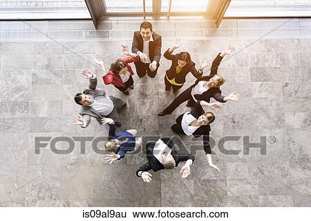 Overhead view of business team in circle jumping for joy View Large Photo Image Stock Photograph - Overhead view of business team in circle jumping for joy. Fotosearch