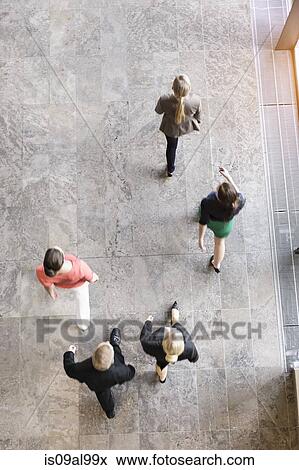 Overhead view of businesswomen and man walking in same direction View Large Photo Image Stock Photo - Overhead view of businesswomen and man walking in same direction. Fotosearch
