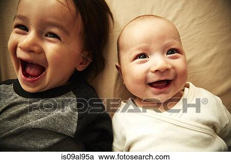 Overhead view of male toddler and baby brother laughing View Large Photo Image Stock Image - Overhead view of male toddler and baby brother laughing. Fotosearch