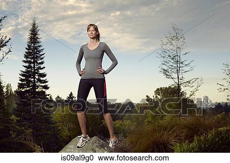 Portrait of female runner on top of boulder in park View Large Photo Image Stock Image - Portrait of female runner on top of boulder in park. Fotosearch