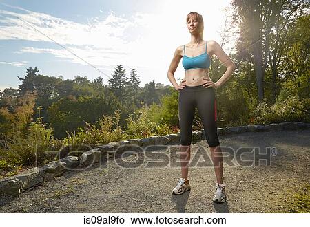 Portrait of female runner with hands on hips in park View Large Photo Image Picture - Portrait of female runner with hands on hips in park. Fotosearch