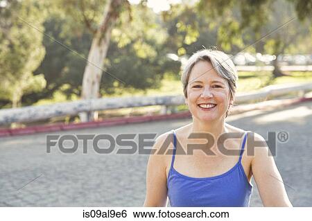 Stock Photograph - Portrait of mature female runner in park. Fotosearch