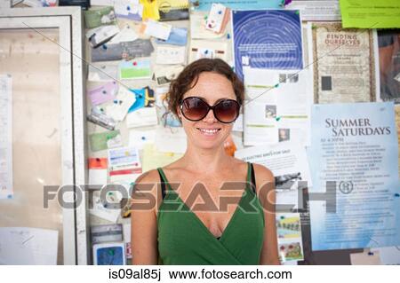 Portrait of smiling mid adult woman in front of community notice board View Large Photo Image Stock Image - Portrait of smiling mid adult woman in front of community notice board. Fotosearch