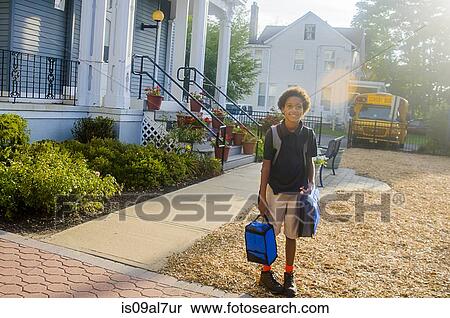 Stock Photography - Portrait of smiling schoolgirl outside school. Fotosearch