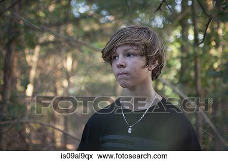Portrait of teenage boy in forest looking sideways, Wichita Mountains National Wildlife Refuge, Indiahoma, Oklahoma, USA View Large Photo Image Stock Photo - Portrait of teenage boy in forest looking sideways, Wichita Mountains National Wildlife Refuge, Indiahoma, Oklahoma, USA. Fotosearch