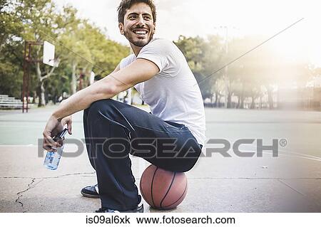 Portrait of young male basketball sitting on ball View Large Photo Image Stock Image - Portrait of young male basketball sitting on ball. Fotosearch
