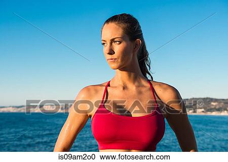 Portrait of young woman wearing sports top, on beach View Large Photo Image Stock Image - Portrait of young woman wearing sports top, on beach. Fotosearch