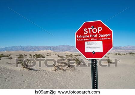 Stock Image - Red stop sign, Stove Pipe Dunes, Death Valley, California, USA. Fotosearch