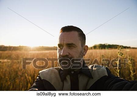 Self portrait of farmer in wheat field at sunset, Plattsburg, Missouri, USA View Large Photo Image Stock Image - Self portrait of farmer in wheat field at sunset, Plattsburg, Missouri, USA. Fotosearch
