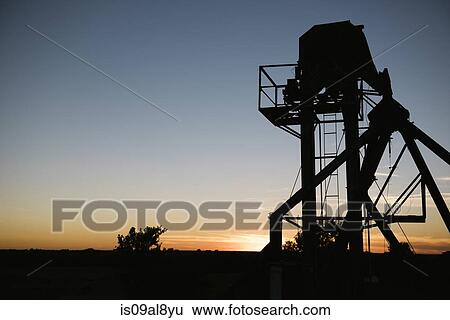 Silhouetted agricultural structure at sunset View Large Photo Image Stock Photograph - Silhouetted agricultural structure at sunset. Fotosearch