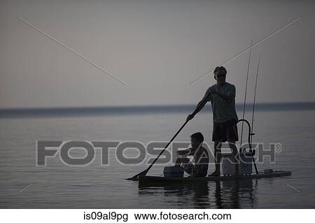 Silhouetted man and teenage son fishing from paddleboard in Lake Superior, Au Train Bay, Michigan, USA View Large Photo Image Stock Image - Silhouetted man and teenage son fishing from paddleboard in Lake Superior, Au Train Bay, Michigan, USA. Fotosearch