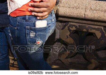 Smartphone in back pocket of jeans View Large Photo Image Stock Image - Smartphone in back pocket of jeans. Fotosearch