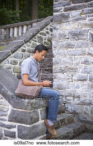 Picture - Student using cell phone. Fotosearch