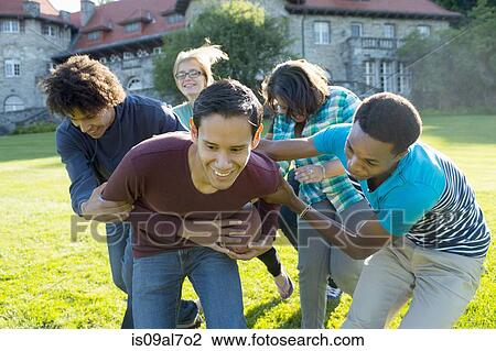 Stock Image - Students playing American football. Fotosearch