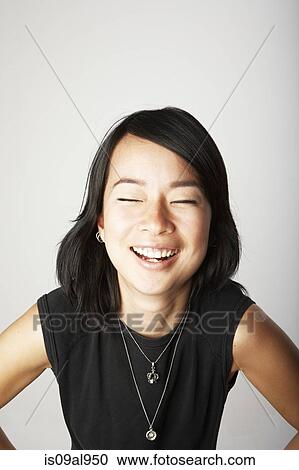 Studio portrait of mid adult woman laughing with eyes closed View Large Photo Image Stock Image - Studio portrait of mid adult woman laughing with eyes closed. Fotosearch
