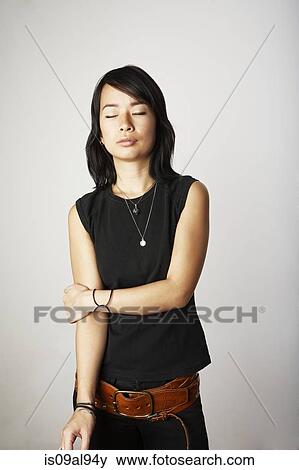 Studio portrait of mid adult woman with eyes closed View Large Photo Image Stock Photo - Studio portrait of mid adult woman with eyes closed. Fotosearch
