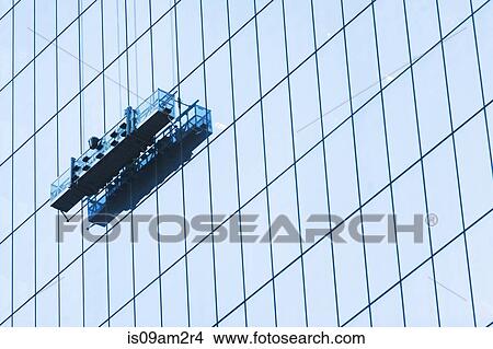 Suspended window cleaning platform on glass building View Large Photo Image Picture - Suspended window cleaning platform on glass building. Fotosearch