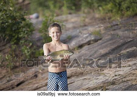 Teenage boy holding up smallmouth bass fish, Lake Superior, Au Train Bay, Michigan, USA View Large Photo Image Stock Image - Teenage boy holding up smallmouth bass fish, Lake Superior, Au Train Bay, Michigan, USA. Fotosearch
