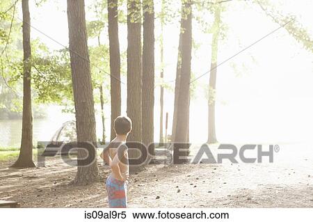 Teenage boy in sunlit forest, Arkansas, USA View Large Photo Image Stock Photography - Teenage boy in sunlit forest, Arkansas, USA. Fotosearch