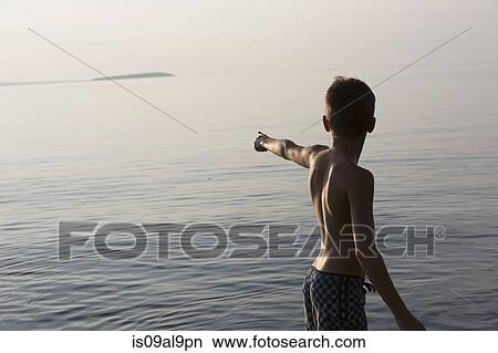 Teenage boy pointing, Lake Superior, Au Train Bay, Michigan, USA View Large Photo Image Picture - Teenage boy pointing, Lake Superior, Au Train Bay, Michigan, USA. Fotosearch
