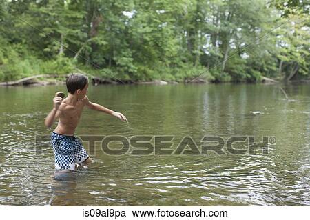 Teenage boy skimming stones in river, Canton, North Carolina, USA View Large Photo Image Stock Image - Teenage boy skimming stones in river, Canton, North Carolina, USA. Fotosearch