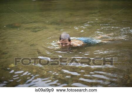 Teenage boy submerged in river, Canton, North Carolina, USA View Large Photo Image Stock Photo - Teenage boy submerged in river, Canton, North Carolina, USA. Fotosearch