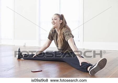 Teenage girl warming up and doing the splits in ballet school View Large Photo Image Stock Photo - Teenage girl warming up and doing the splits in ballet school. Fotosearch