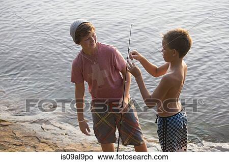 Picture - Teenage twin boys preparing fishing line, Lake Superior, Au Train Bay, Michigan, USA. Fotosearch