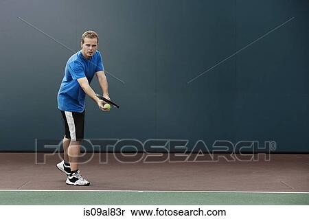 Tennis player about to serve ball in tennis court View Large Photo Image Stock Photography - Tennis player about to serve ball in tennis court. Fotosearch