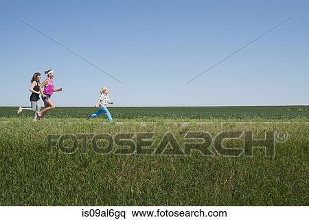 Three people running through field View Large Photo Image Stock Photography - Three people running through field. Fotosearch