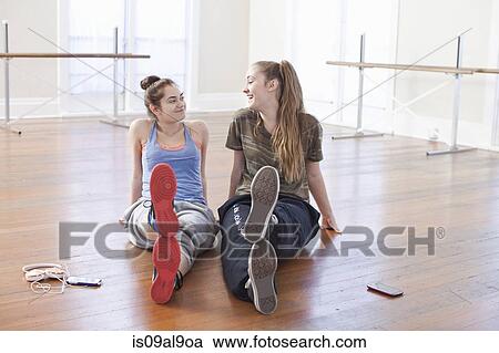 Two teenage girls chatting in ballet school View Large Photo Image Stock Image - Two teenage girls chatting in ballet school. Fotosearch