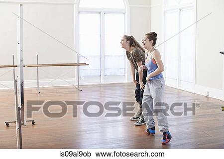 Two teenage girls doing warm up dance in ballet school View Large Photo Image Stock Image - Two teenage girls doing warm up dance in ballet school. Fotosearch