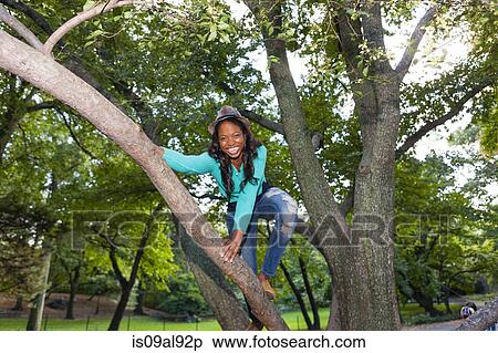 Woman climbing tree, Central Park, New York, USA View Large Photo Image Stock Photography - Woman climbing tree, Central Park, New York, USA. Fotosearch
