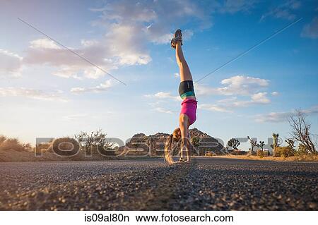 Woman doing hand-stand, Joshua Tree National Park, California, US View Large Photo Image Picture - Woman doing hand-stand, Joshua Tree National Park, California, US. Fotosearch
