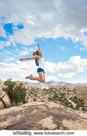 Woman jumping for joy on mountain, Joshua Tree National Park, California, US View Large Photo Image Stock Image - Woman jumping for joy on mountain, Joshua Tree National Park, California, US. Fotosearch
