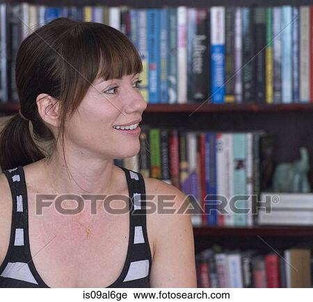 Stock Image - Woman looking away smiling, portrait. Fotosearch