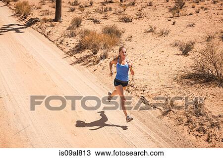 Stock Image - Woman running, Joshua Tree National Park, California, US. Fotosearch