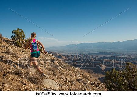Woman running on mountain, Joshua Tree National Park, California, US View Large Photo Image Stock Photo - Woman running on mountain, Joshua Tree National Park, California, US. Fotosearch